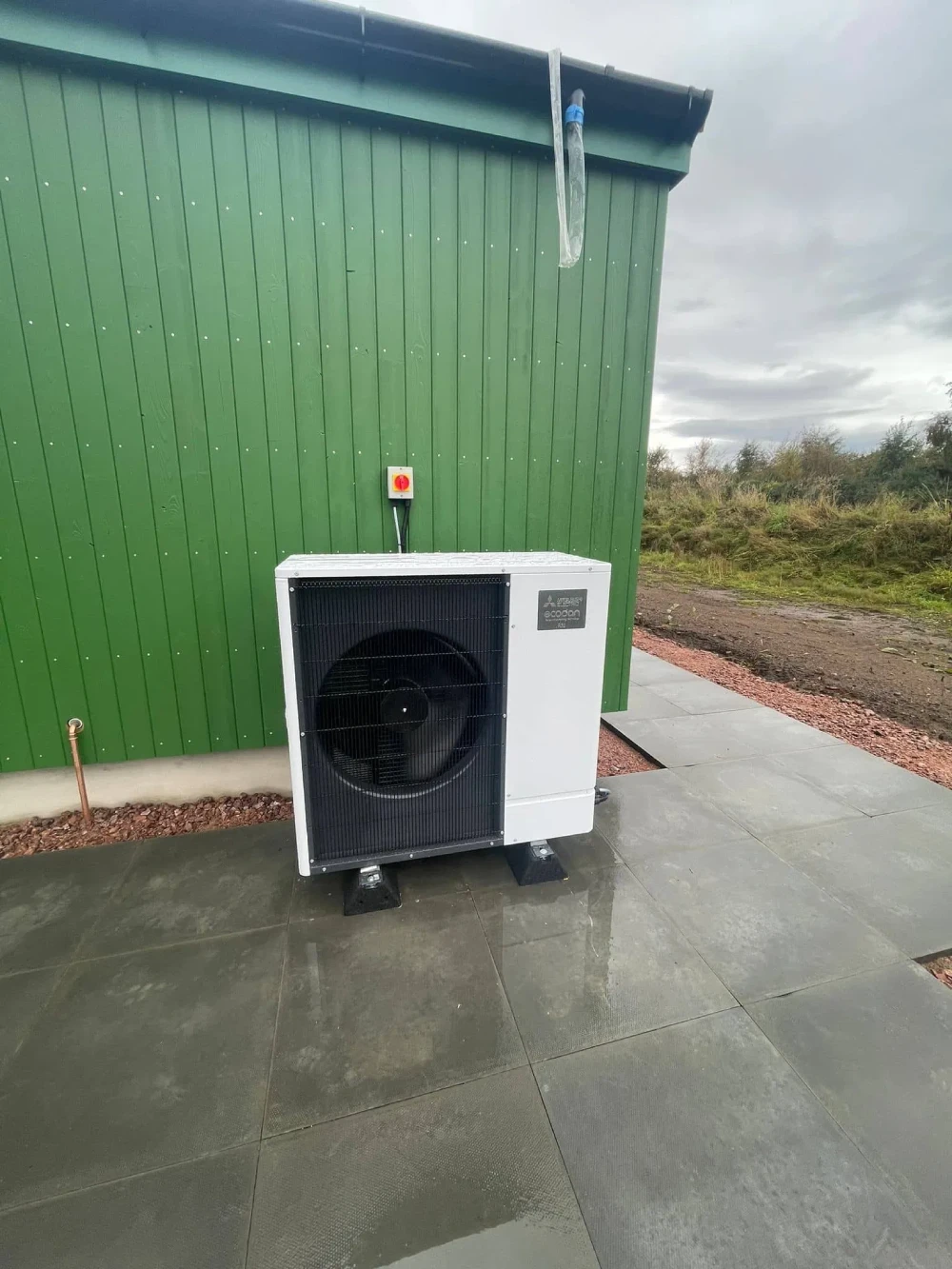 Outdoor heat pump beside green building