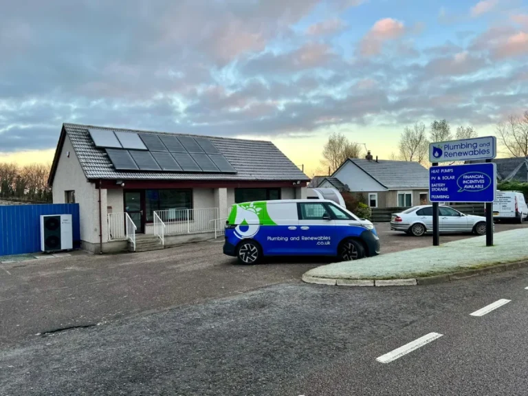 Building with solar panels and company van.