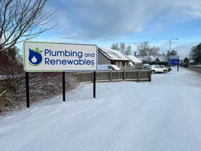 Snowy landscape with Plumbing and Renewables sign.